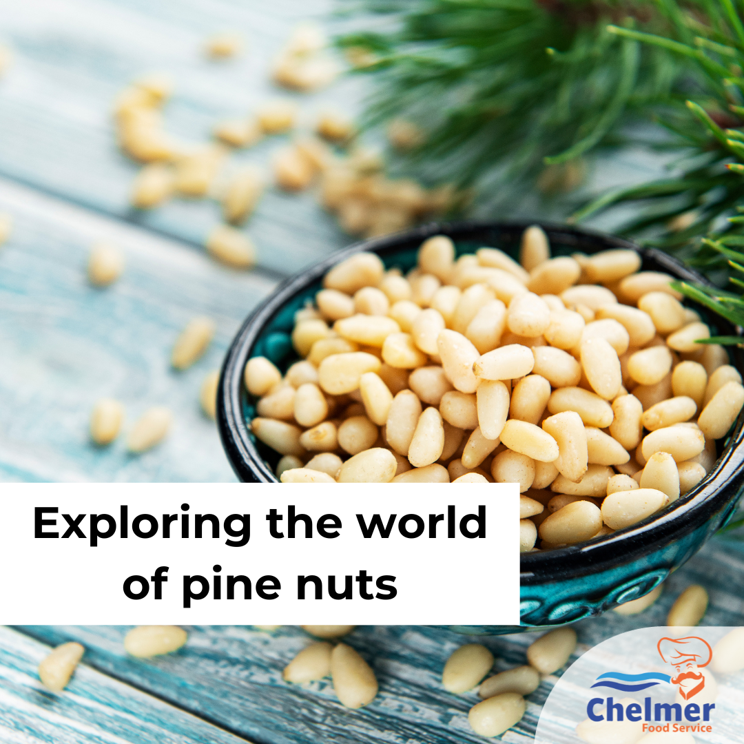 Bowl of pine nuts with pine needles in the background.